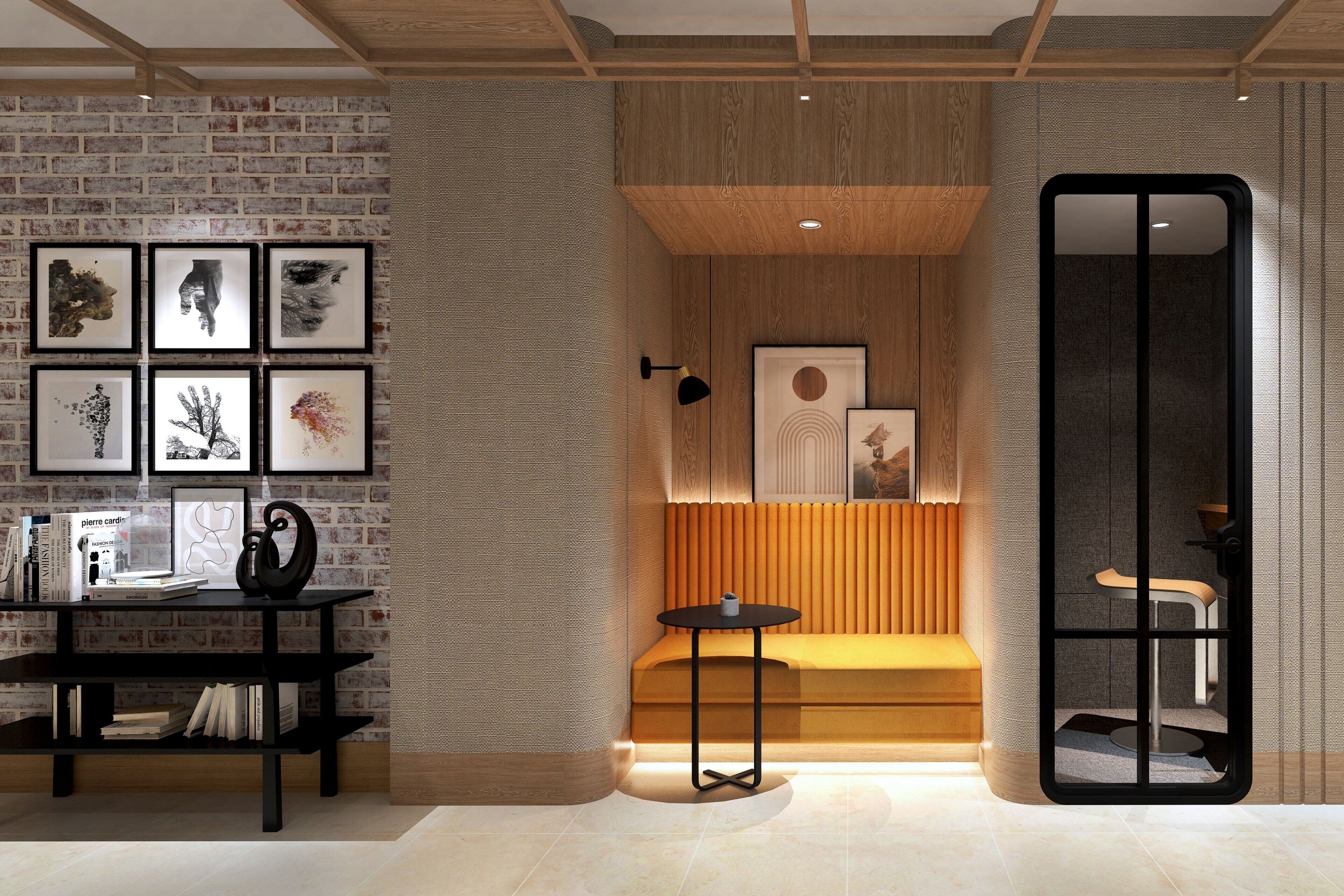 A modern interior with a brick wall, a wooden bench, a round table, and a bookshelf.