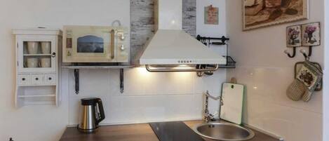 Microwave, stovetop, cookware/dishes/utensils, dining tables