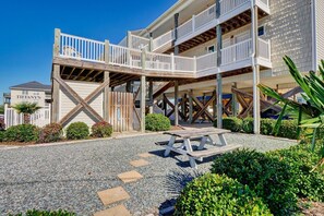 Enjoy a relaxing stay in a beachfront hotel with a unique architectural style, featuring balconies and a covered outdoor area.