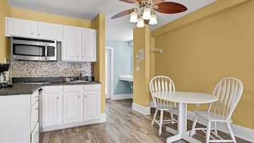 Coffee/tea maker, cookware/dishes/utensils, dining tables