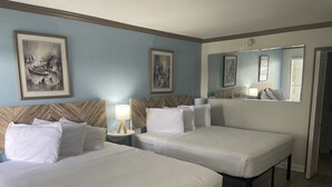 A hotel room with two beds, a nightstand with a lamp, and a large mirror. - ALL BRAND-NEW Waterfront room-Heated Pool, Tiki Bar, Gym (Sarasota)
