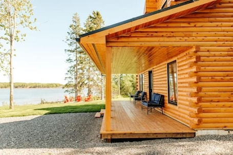 Property grounds. Unwind by the Sea at The Salty Pearl: Your Charming Coastal Log Cottage