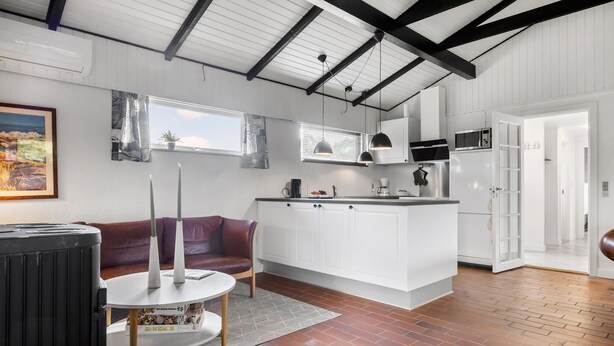 A modern kitchen with white cabinetry, a built-in microwave, and a stainless steel refrigerator. - Cozy home in Sydals with WiFi (Sydals)
