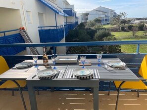 Enjoy al fresco dining on the balcony with a view of the surrounding neighborhood.
