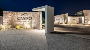 A modern building with a stone facade and a sign that reads "CAMPO PREMIUM STAY". - Campo Premium Villa with Private Pool (Kos)