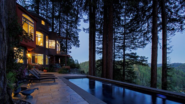 A modern house with a swimming pool, surrounded by tall trees. - Palazzo Marzino ~ An Italian Inspired Villa ~ 3 Bed ~ 3 Bath ~ Pool ~ Hot Tub ~ (Guerneville)