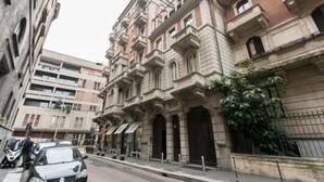A historic building with classical architecture, featuring multiple balconies and large windows. - Apartment Togni "y" (Milano)
