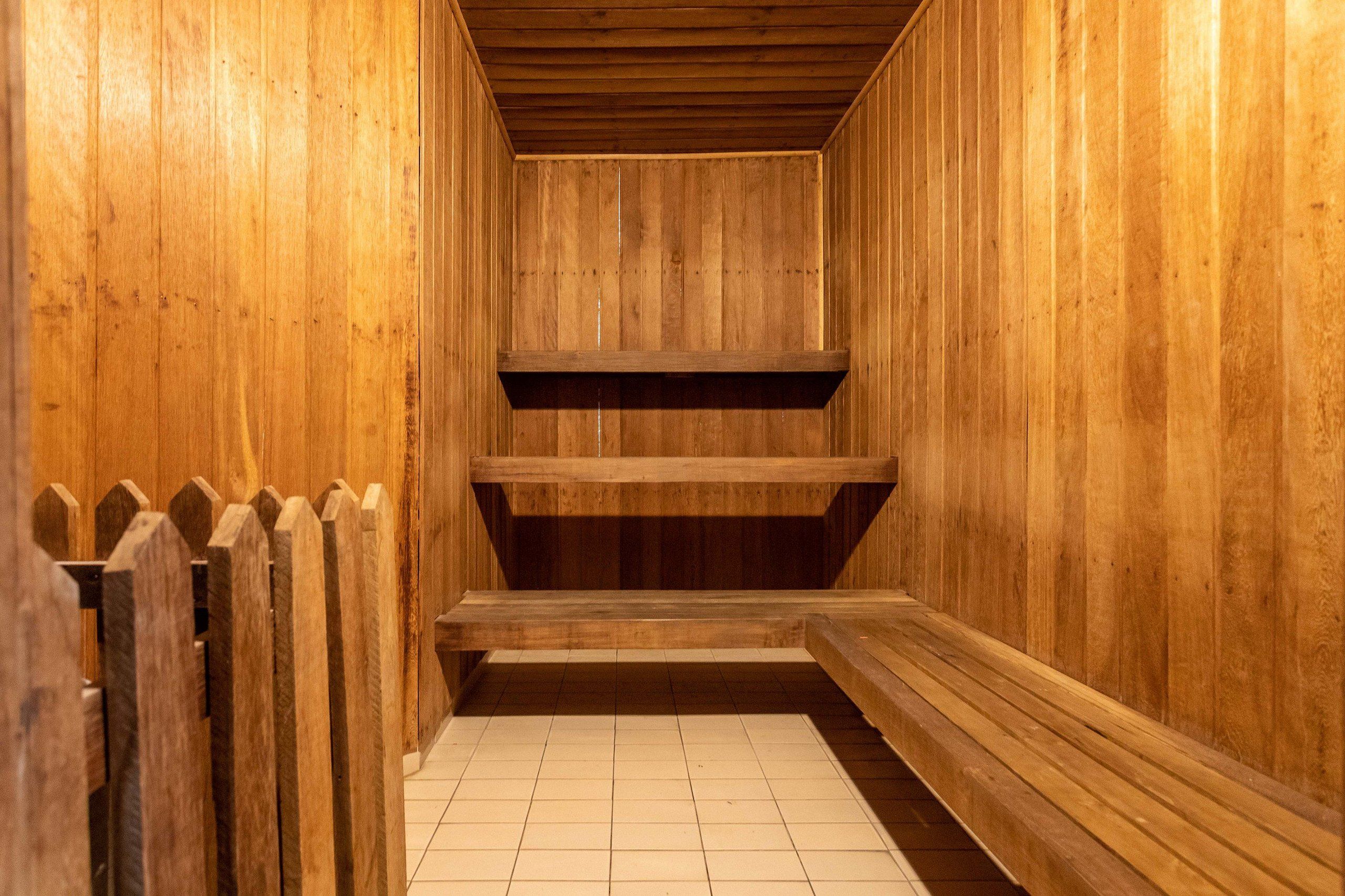 A wooden interior with a tiled floor and a wooden bench.