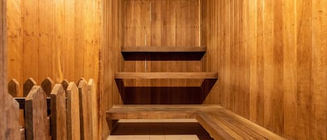 A wooden interior with a tiled floor and a wooden bench.