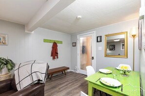 Cozy retreat with a dining table for two, a bench, and a mirror.