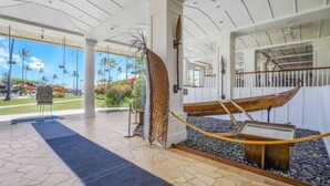 A lobby with a boat display, a tropical garden view, and a sign indicating a 6 feet apart social distancing guideline. - Lagoon View Resort Retreat (Lihue)