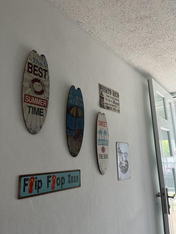 A wall with various signs, including one that says "The Best Summer Time" and another that says "Foop Foop Zone".