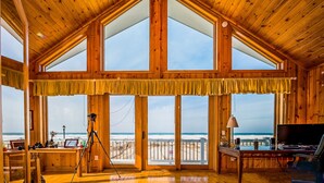 A spacious room with large windows, wooden ceiling, and a desk with a computer. - Sunset Kisses. Beachfront Luxury vacation rental (South Haven)
