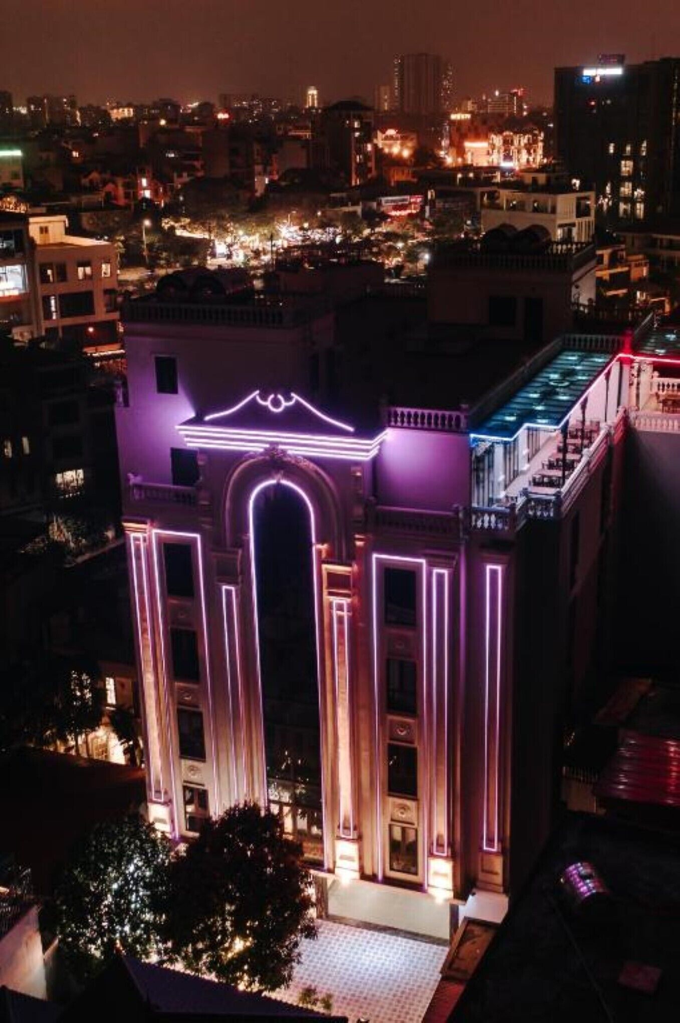 Un edificio con arcos iluminados y un balcón.