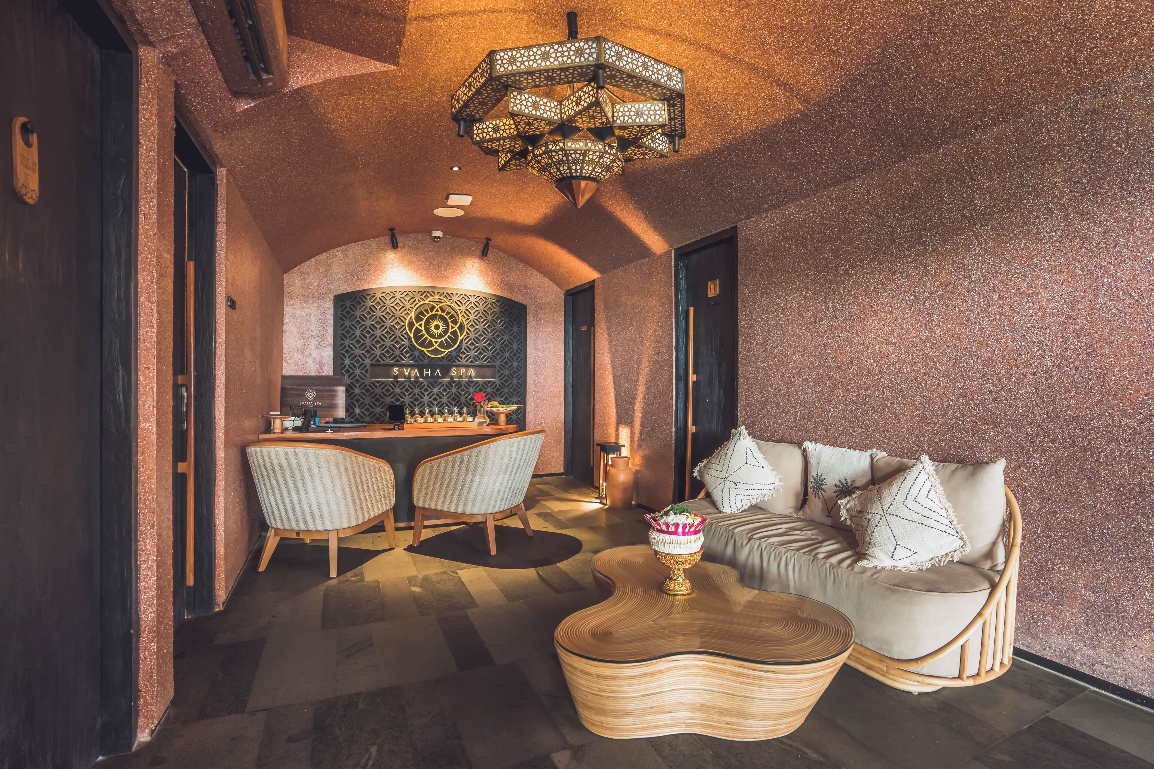 A modern interior with a sofa, chairs, a coffee table, and a decorative chandelier.
