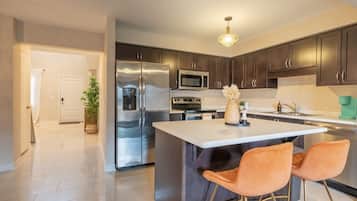 Fridge, coffee/tea maker, high chair, cookware/dishes/utensils