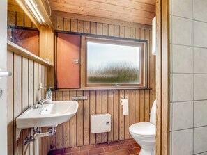 Bathroom features a sink, toilet, and window with a frosted glass pane.