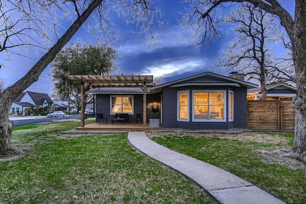 Charming exterior with a welcoming front porch and beautifully landscaped yard.
