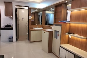 A modern kitchen with a sink, cabinets, and a countertop.