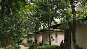 A pathway leading to a building with a staircase and a door. - Banbas Resort, Chitwan (Sauraha)