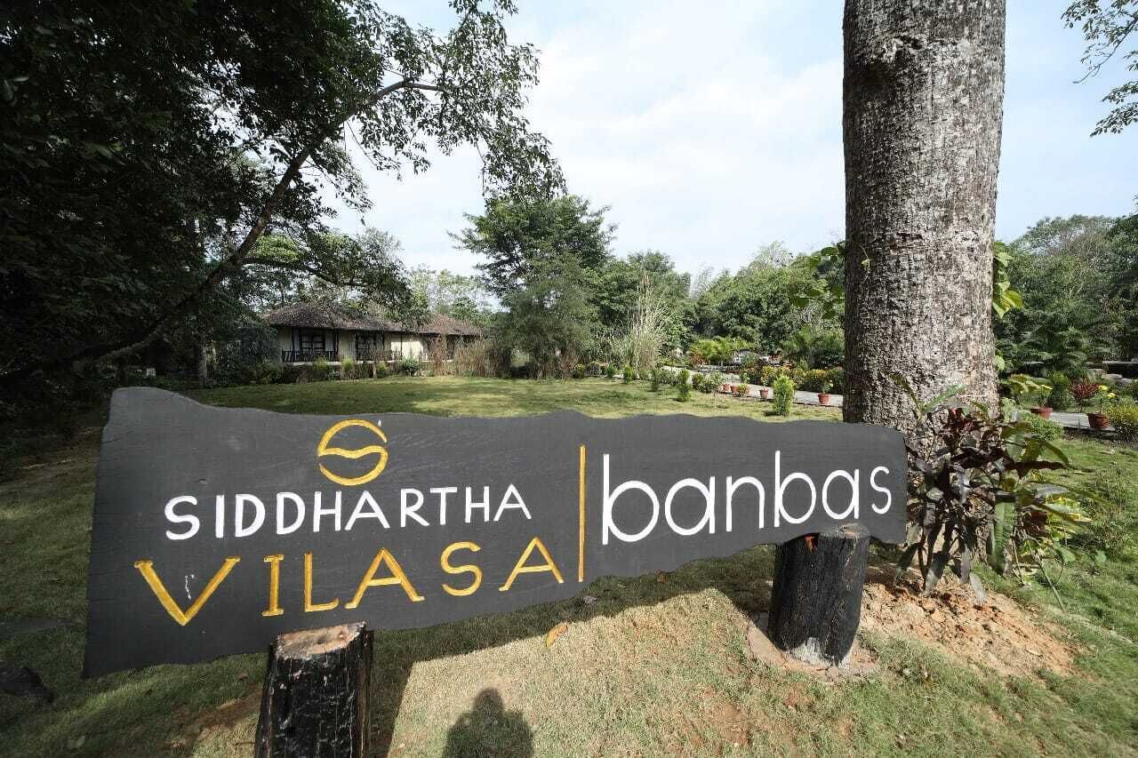 A sign for Siddhartha Vilasa with a logo and name.