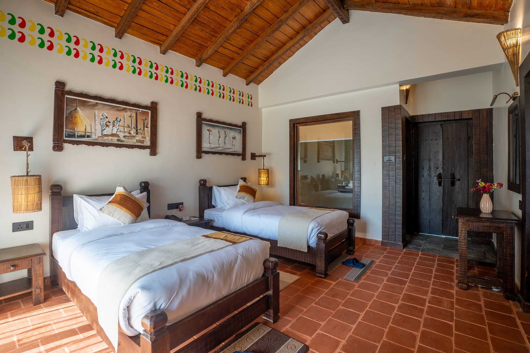 A room with two wooden beds, a large mirror, and a wooden ceiling.