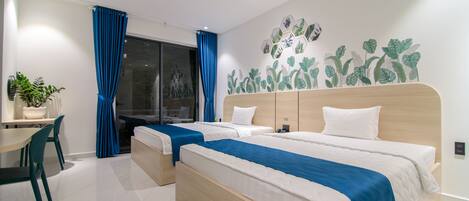 A modern hotel room with two beds, a desk, and a chair.