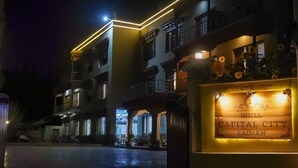 Entrada de un hotel con un cartel que dice "Hotel Capital City Ladakh".