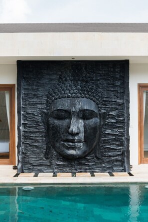 A Buddha statue in front of a pool. - Sitara Villas Seminyak (Seminyak)