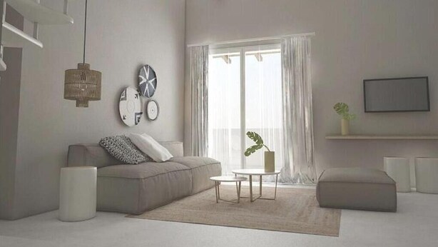 A modern living room with a sofa, a small table, a plant, and a large window with curtains. - Avres Apartments (Skiathos)