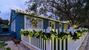 A house with a white picket fence, decorated with Christmas lights and wreaths. - Romantic Getaway in Historic District! Walk to Attractions, Minutes to Beach! $300 in Free Tickets! (St. Augustine)