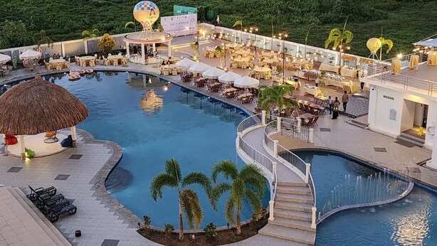 A resort pool area with multiple seating areas, a hot tub, and a covered seating area. - Aimas Hotel & Convention Centre (Sorong)