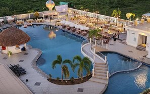 A resort pool area with multiple seating areas, a hot tub, and a covered seating area. - Aimas Hotel & Convention Centre (Sorong)