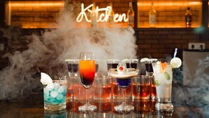 Een bar met verschillende drankjes en een achtergrond van bakstenen.