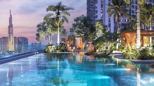 A modern residential area with a pool, palm trees, and high-rise buildings in the background. - Lumiere Riverside Luxury Apartment (Ho Chi Minh City)