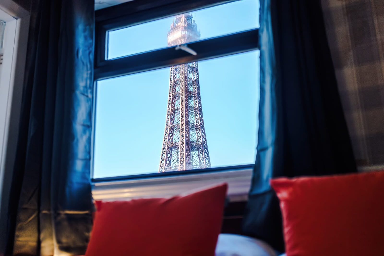 A window with a view of the Eiffel Tower.
