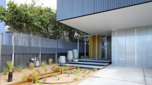 A modern building with a flat roof, large windows, and a minimalist design.