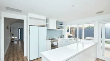 Fridge, coffee/tea maker, cookware/dishes/utensils, dining tables