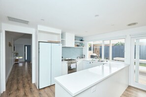 Fridge, coffee/tea maker, cookware/dishes/utensils, dining tables - Coastal Family Lodge (Torquay)