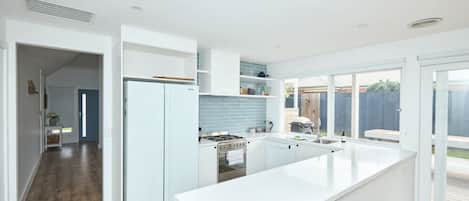 Fridge, coffee/tea maker, cookware/dishes/utensils, dining tables