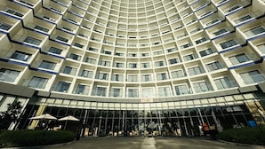 A modern hotel with a curved facade, multiple balconies, and a glass entrance. - Seaview Cam Ranh (Bac Cam Ranh)