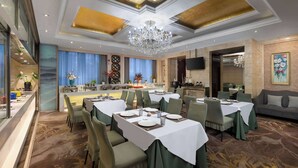 A dining area with tables set for service, a chandelier, and a television mounted on the wall. - Days Inn by Wyndham Beijing Haidian (Beijing)