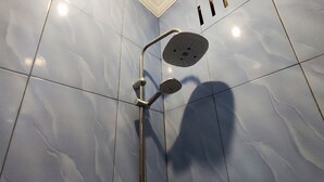 A shower with a handheld showerhead and a wall-mounted control panel. - Hotel O Aksana Homestay SyariahNearWonderland Trik Art (Purwokerto)