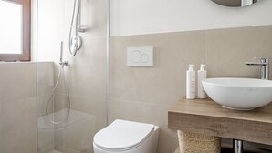 A modern bathroom with a glass-enclosed shower, a white toilet, and a wooden vanity with a large white sink. - La terrazza sul vicolo della Giudecca by Wonderful Italy (Syracuse)
