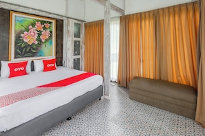 A hotel room with a bed, a painting, a sofa, and curtains. - Hotel O Tungku Klui Hotel (Senggigi)
