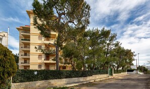 Set amidst mature trees and a well-manicured hedge, this building offers a serene atmosphere.