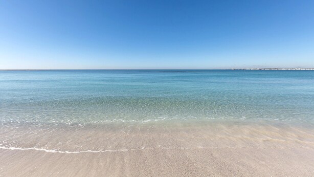 A beach with clear blue water and a sandy shore. - 3730 Appartamento Valencia by Barbarhouse (Porto Cesareo)