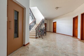Stairs lead to an upper level, with bicycles parked nearby.