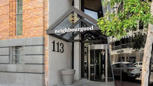 A modern building with a sign reading "neighbourhood 113". - Neighbourgood Loop (Cape Town)