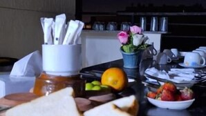 A kitchen counter with bread, fruit, and a coffee maker. - Panorama 3 Pyramids View Inn (Giza)